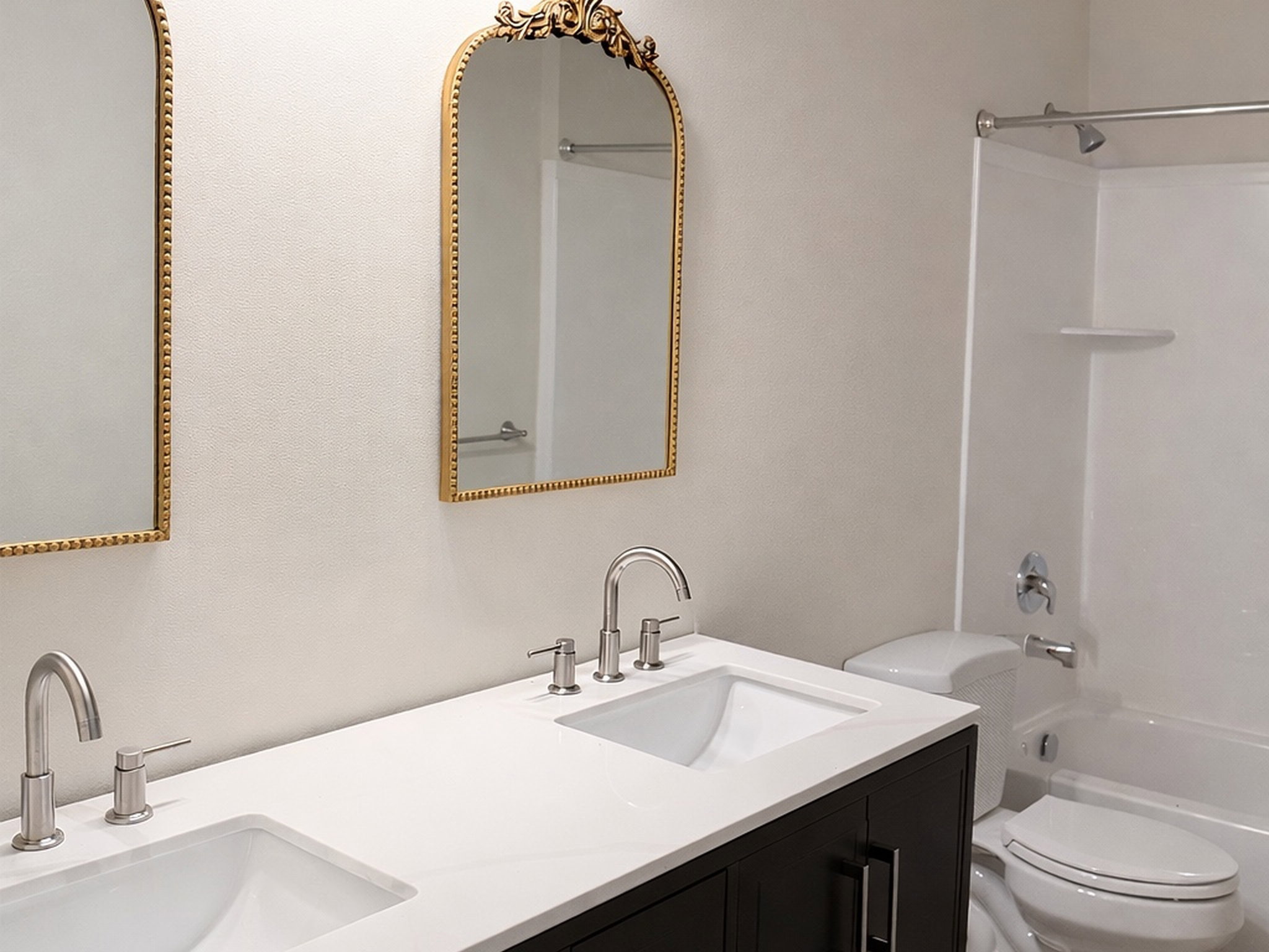 Full bath featuring double vanity and bathtub / shower combination