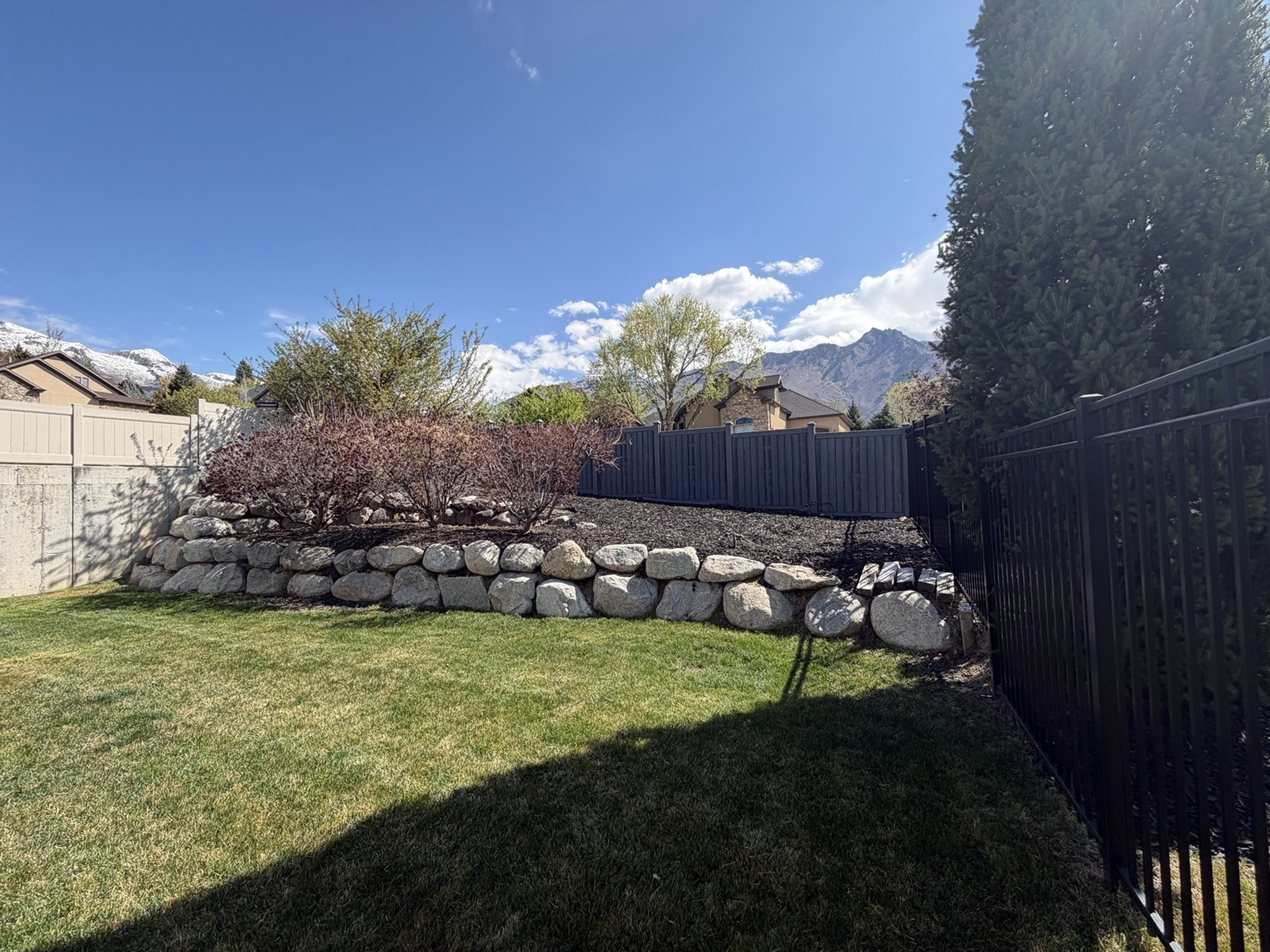 Fenced backyard featuring a mountain view