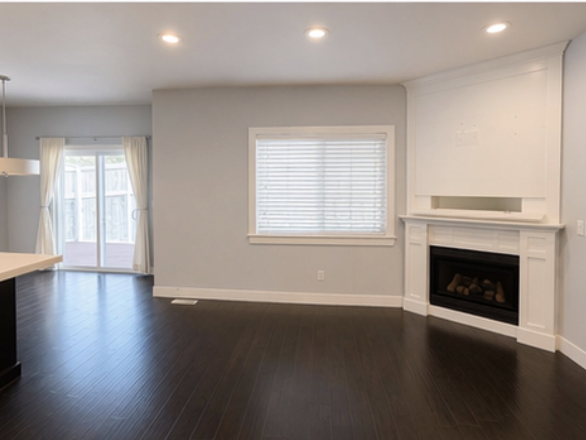 Unfurnished living room featuring recessed lighting, a fireplace, and dark wood-style floors