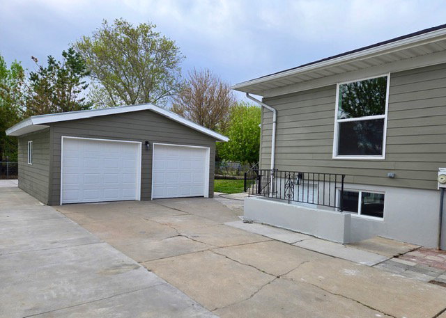 Walkout basement entrance, detached oversized 2 car garage, and extended RV pad