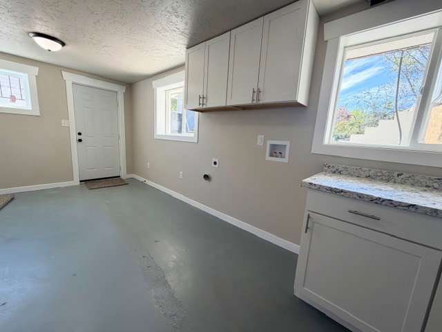 Finished laundry/utility room with walkout entrance