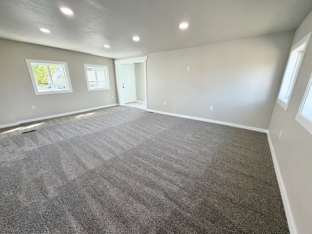 Carpeted room with recessed lighting