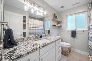 Full bath with vanity and a shower with shower curtain