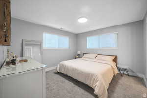 Bedroom featuring light colored carpet and baseboards