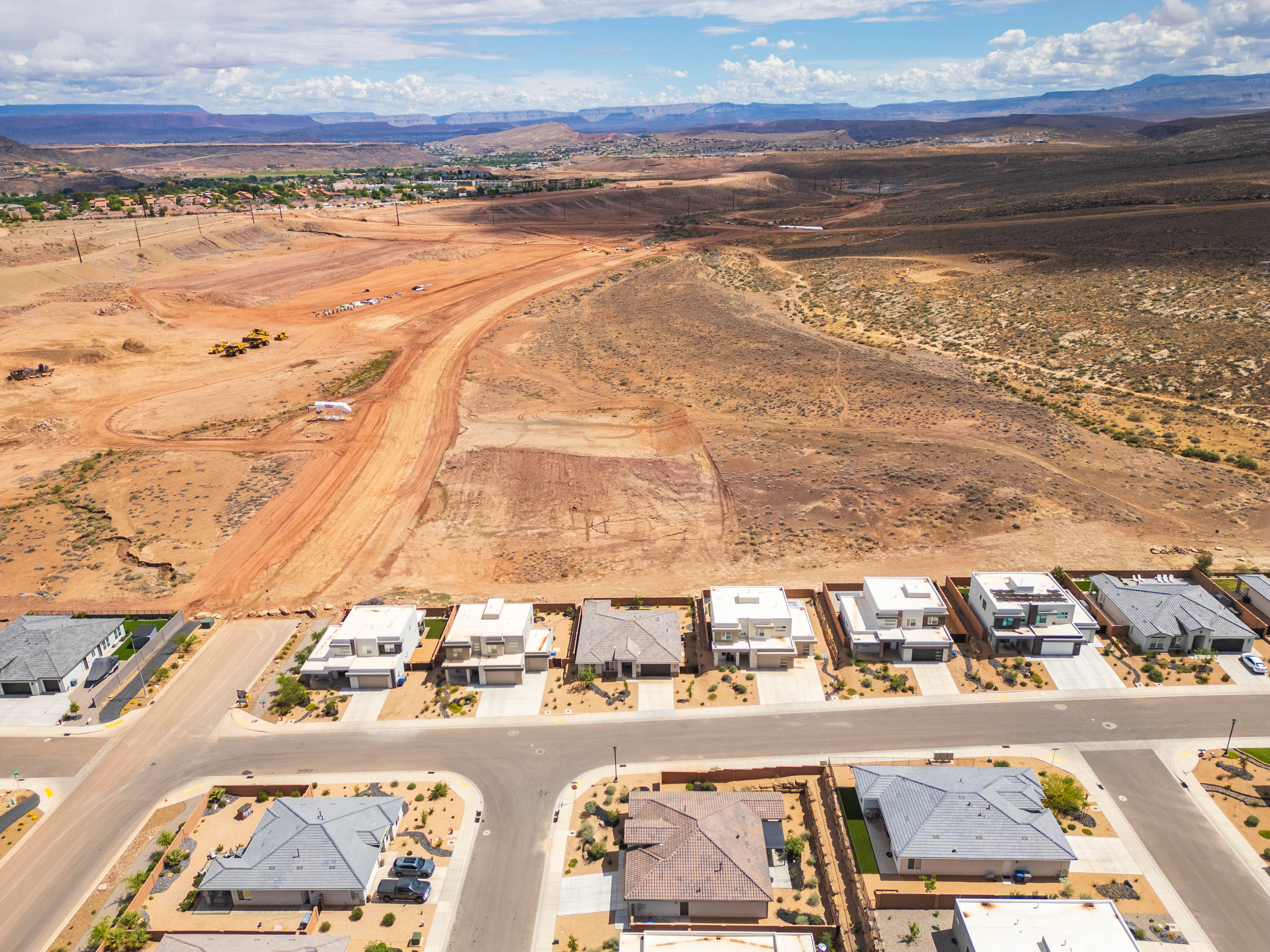 Overview of rural landscape featuring nearby suburban area and mountains