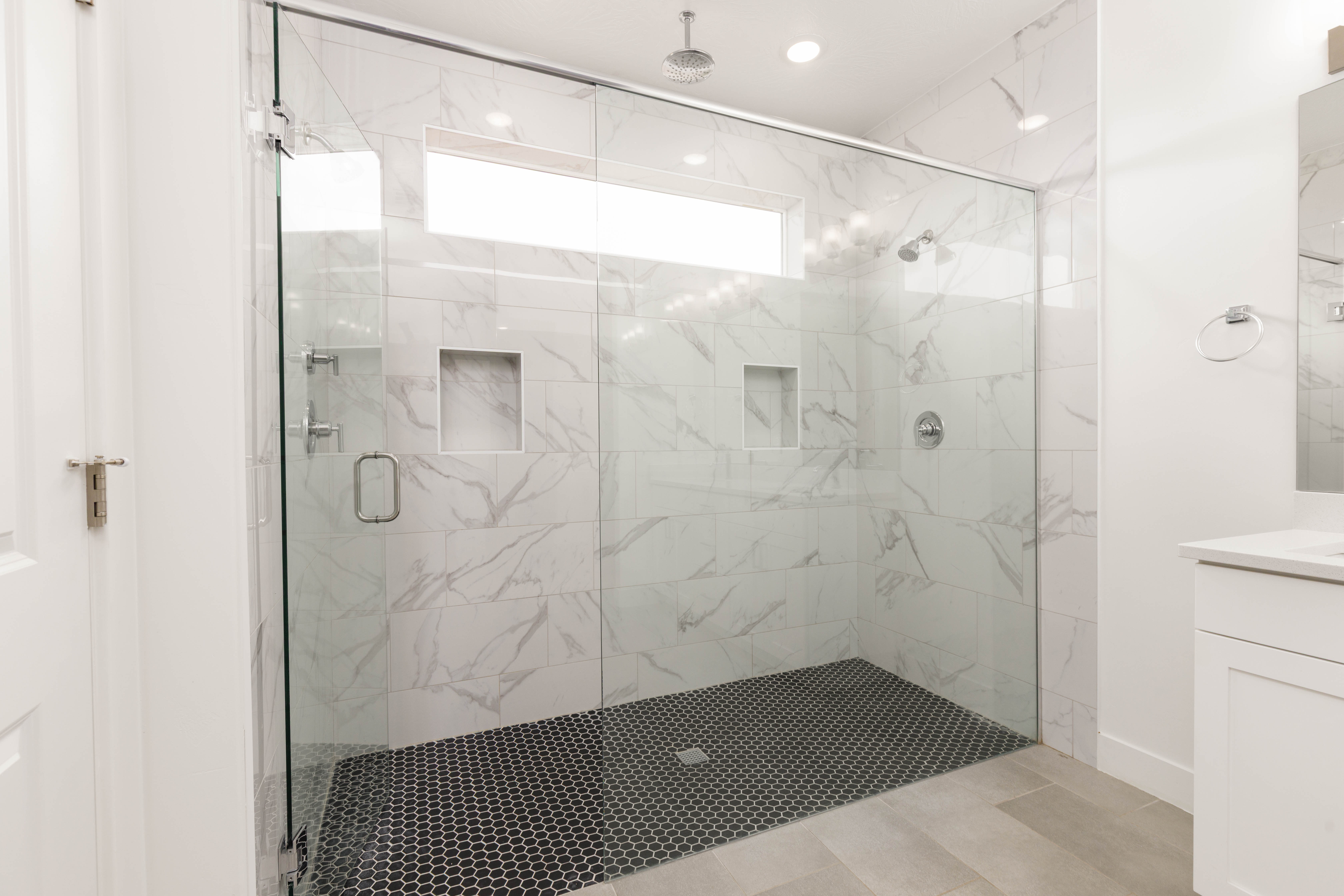 Full bathroom featuring vanity and a marble finish shower