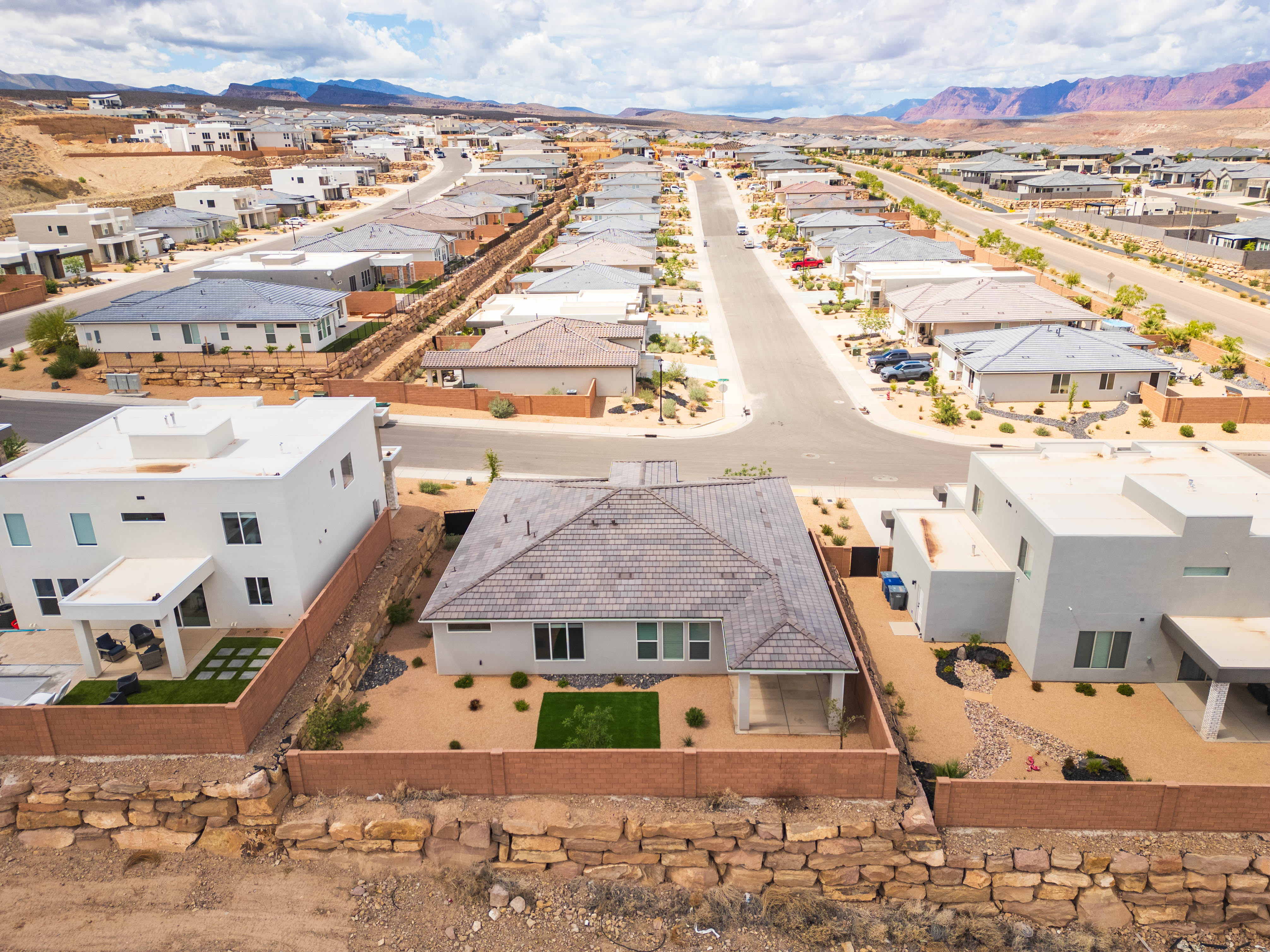Aerial perspective of suburban area featuring a mountain backdrop