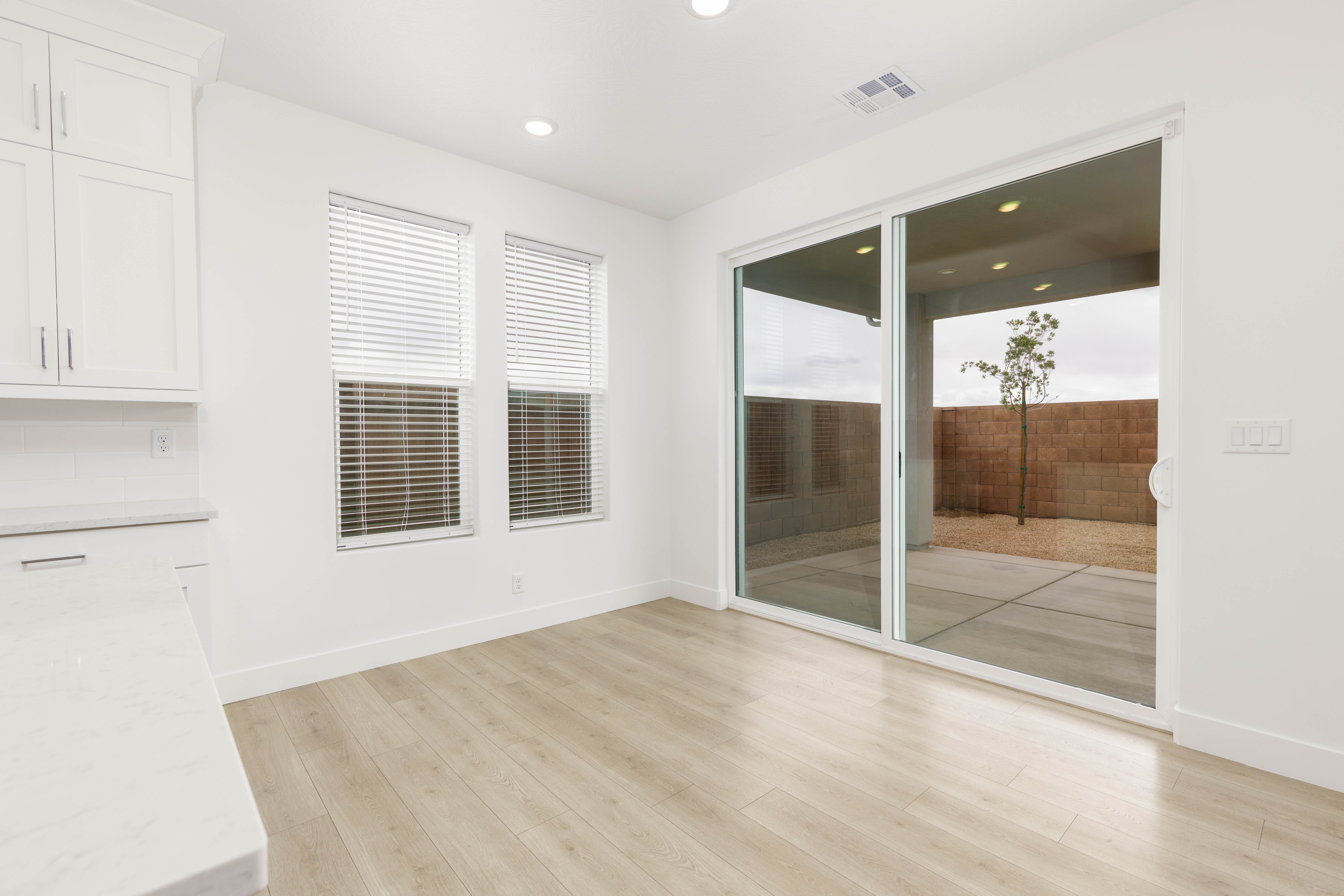 Unfurnished dining area with light wood-type flooring and recessed lighting