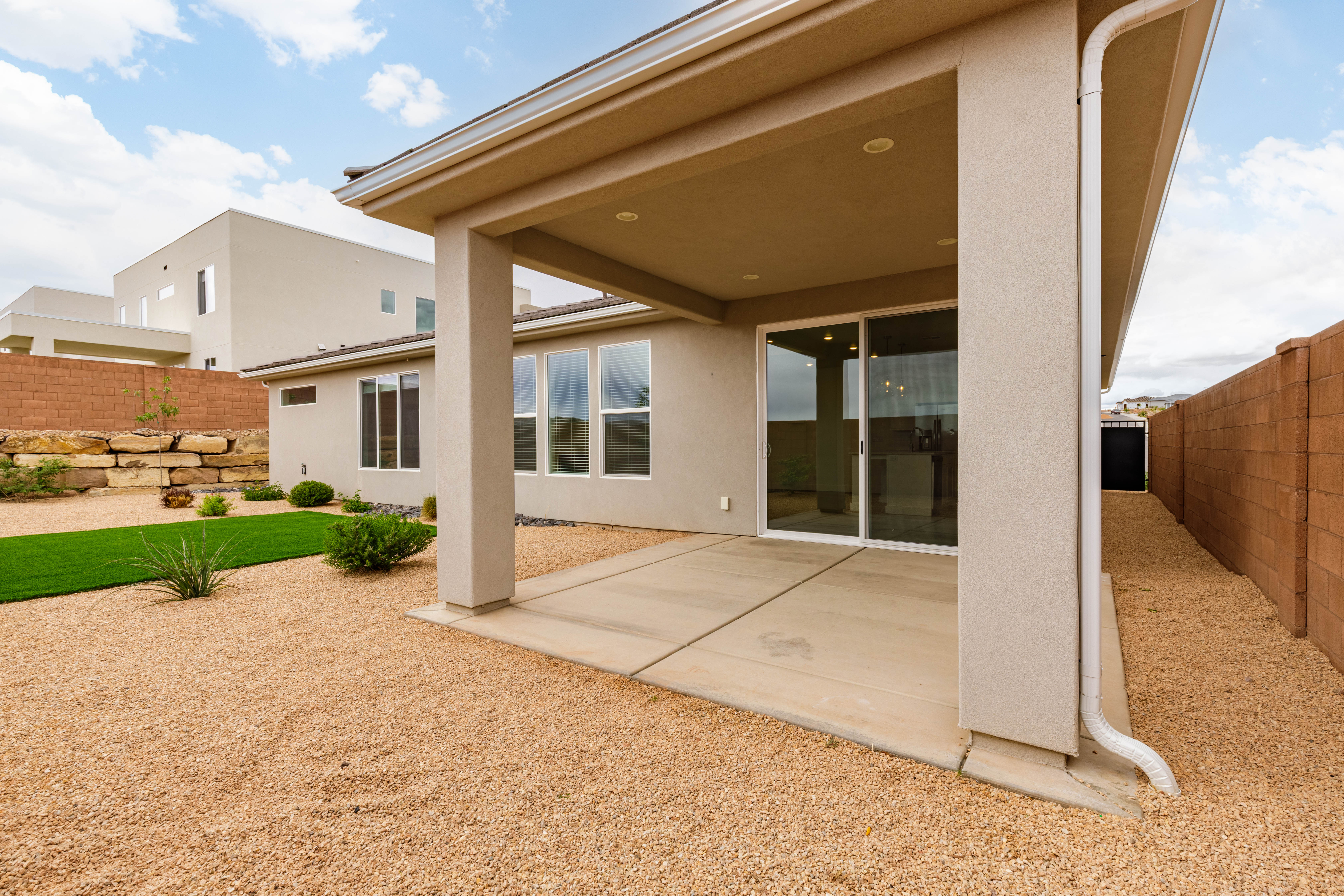 Rear view of property featuring a patio, a fenced backyard, and stucco siding