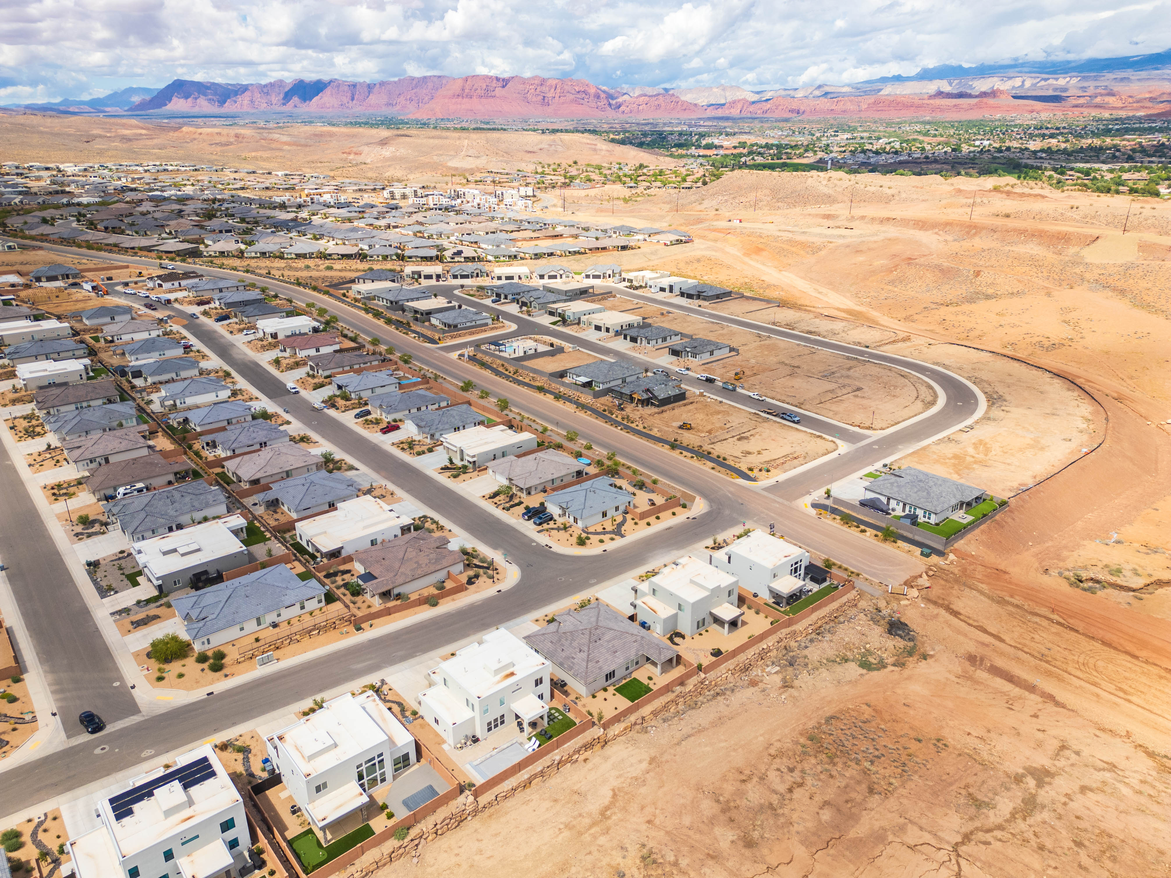 Aerial view of residential area featuring mountains and a desert landscape