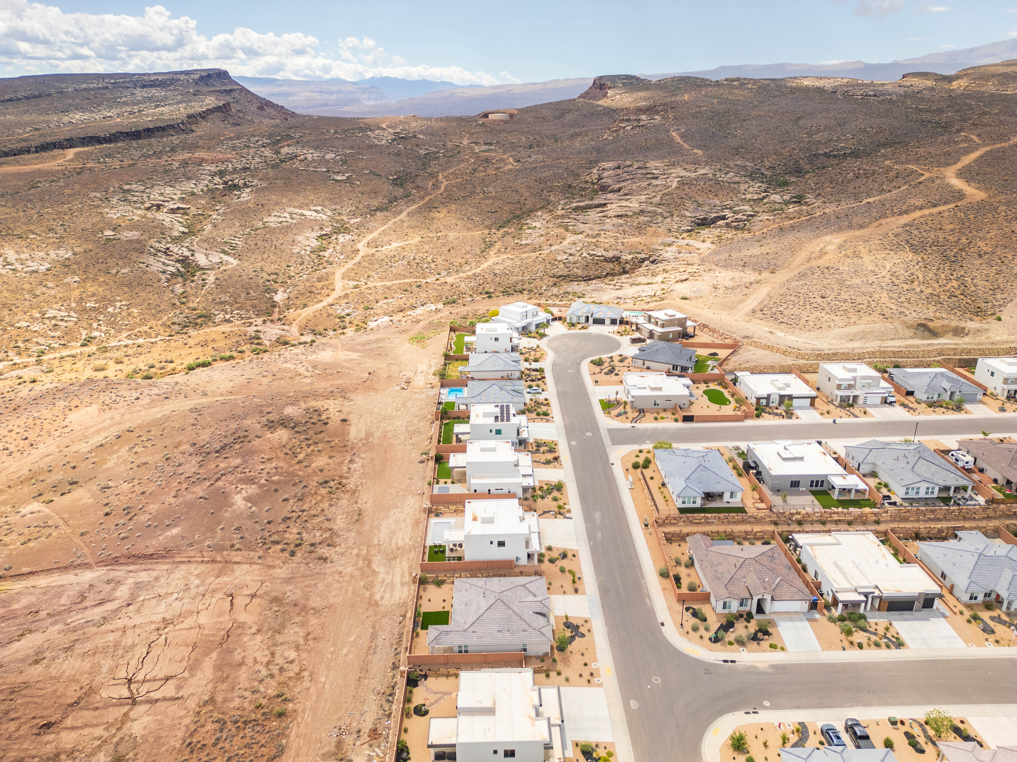 Aerial perspective of suburban area featuring mountains and a desert landscape