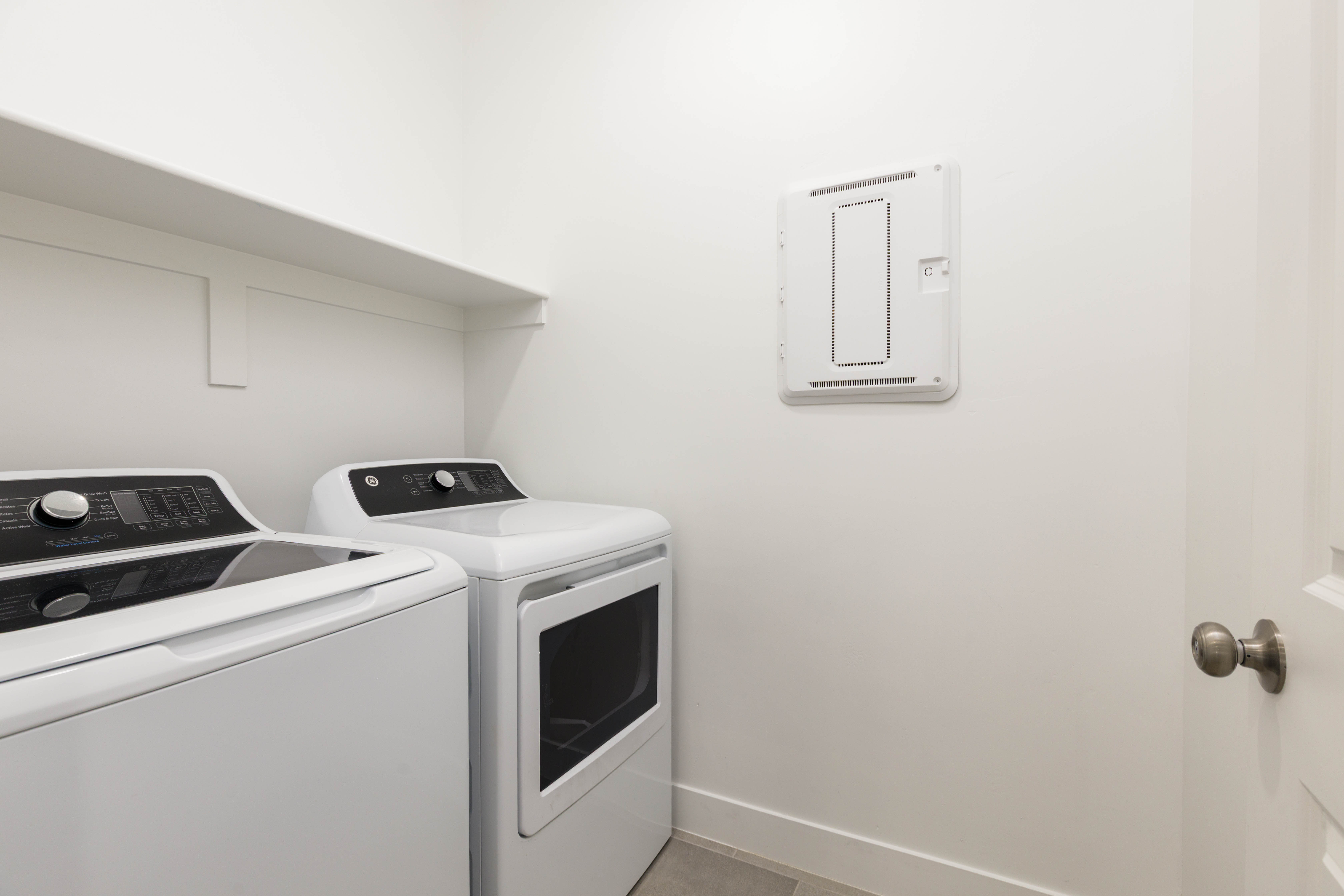 Laundry room with baseboards and separate washer and dryer