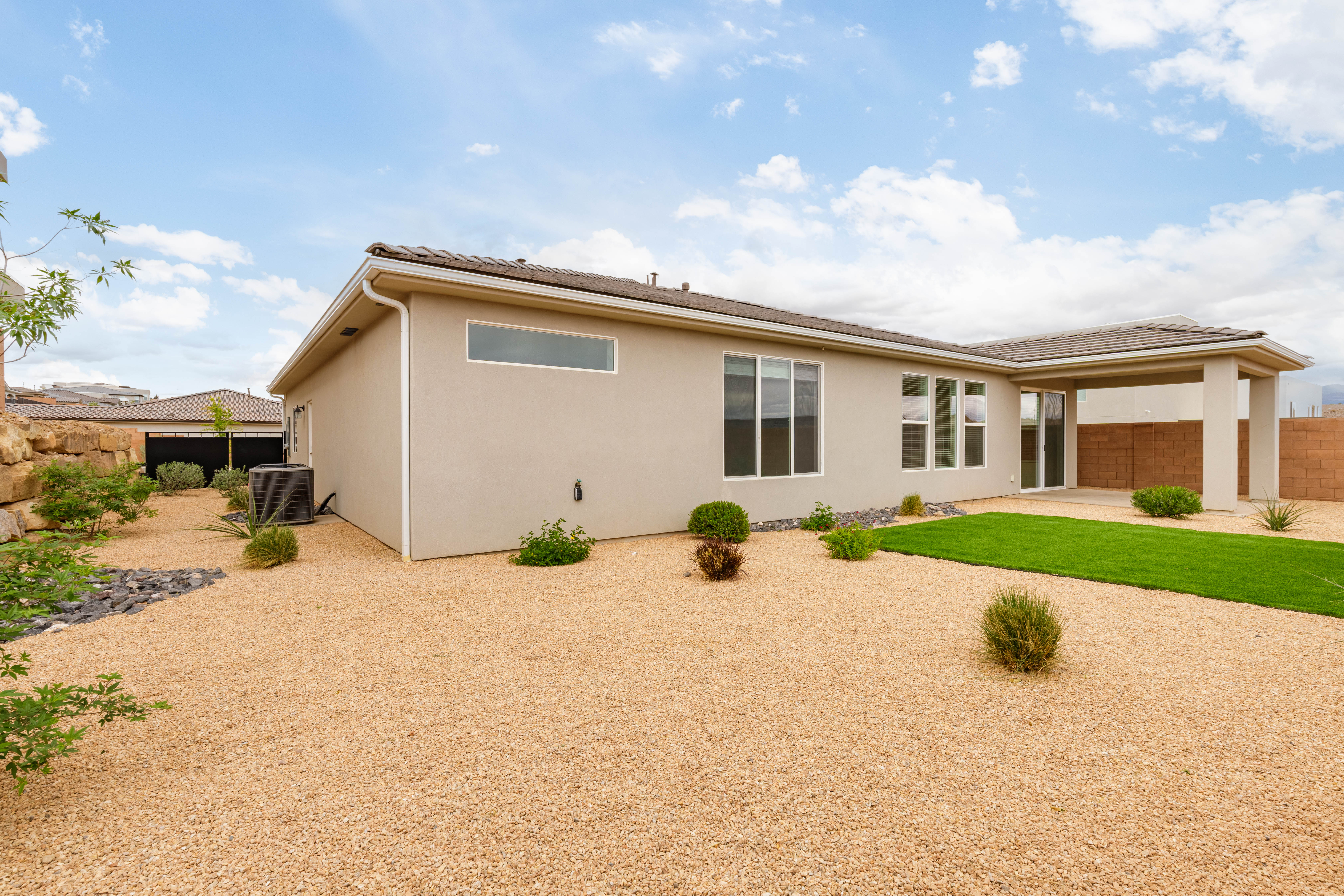 Back of house featuring a patio area and stucco siding