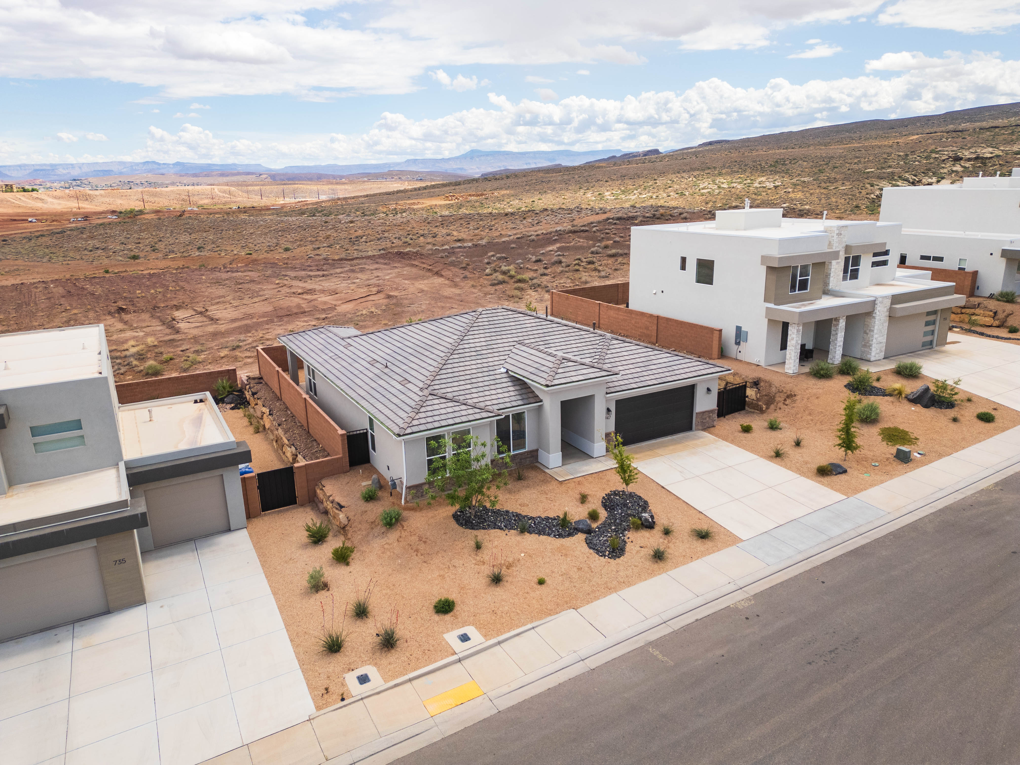 Aerial view of property and surrounding area with a mountain backdrop
