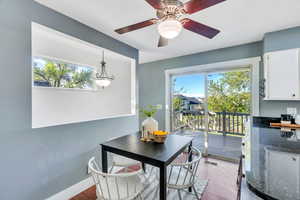 Dining space featuring plenty of natural light, wood finished floors, and a ceiling fan