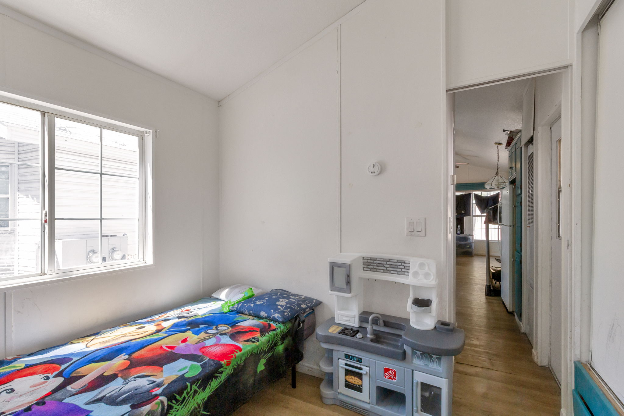 Bedroom with light wood-type flooring and multiple windows