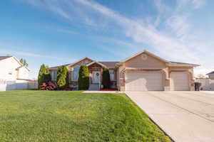 Ranch-style house featuring a garage, brick siding, and concrete driveway