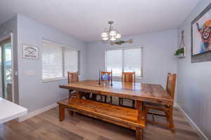 Dining area featuring hardwood / wood-style floors and suspended lighting