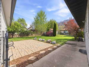 Fenced backyard with a patio area
