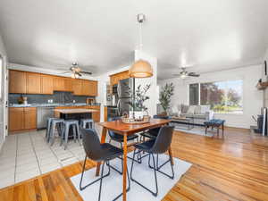 Dining room featuring a ceiling fan and light wood-type flooring