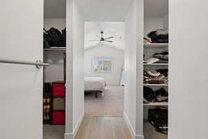 View of primary bedroom dual walk-in closets