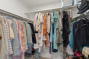 View of primary bedroom walk-in closet