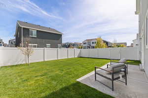 Fenced backyard with healthy lawn and spacious patio
