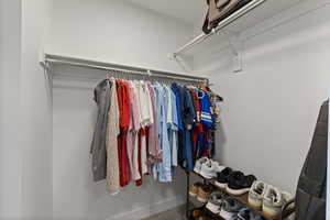 View of primary bedroom walk-in closet