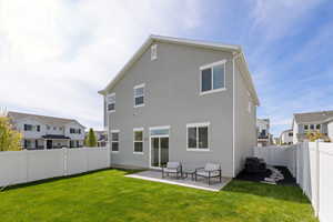 Fenced backyard with healthy lawn and spacious patio