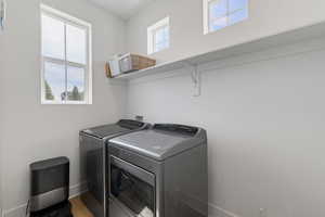 Laundry room featuring plenty of natural light, shelving, and separate washer and dryer