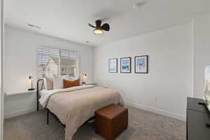Second floor spare bedroom with carpet, floating shelving, and ceiling fan