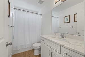 Second floor full bathroom featuring vanity with white cabinets and upgraded quartz countertops, LVP flooring, and a tub/shower combination