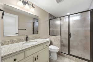 Bathroom featuring vanity, a shower stall, and light tile patterned flooring