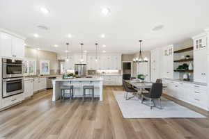 Kitchen featuring white cabinets, stainless steel appliances, and a center island