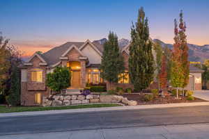 View of front of house with stone siding and stucco siding