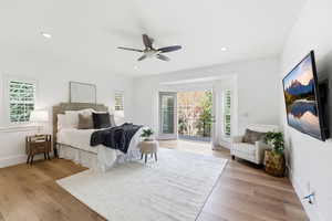 Bedroom with light wood finished floors, multiple windows, access to outside, a ceiling fan, and recessed lighting