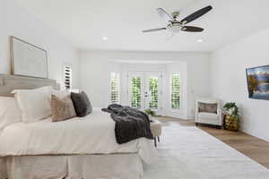Bedroom with french doors, access to outside, light wood-style flooring, a ceiling fan, and recessed lighting