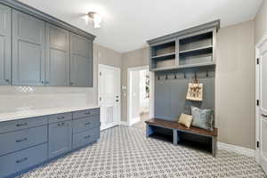Mudroom with light floors and baseboards