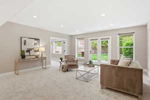 Living room with light carpet and recessed lighting