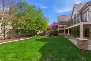 Fenced yard with a balcony and a patio area