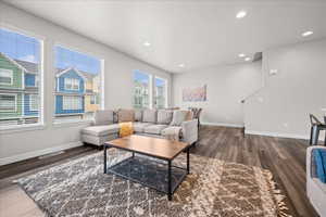 Living area featuring dark wood-style floors and recessed lighting