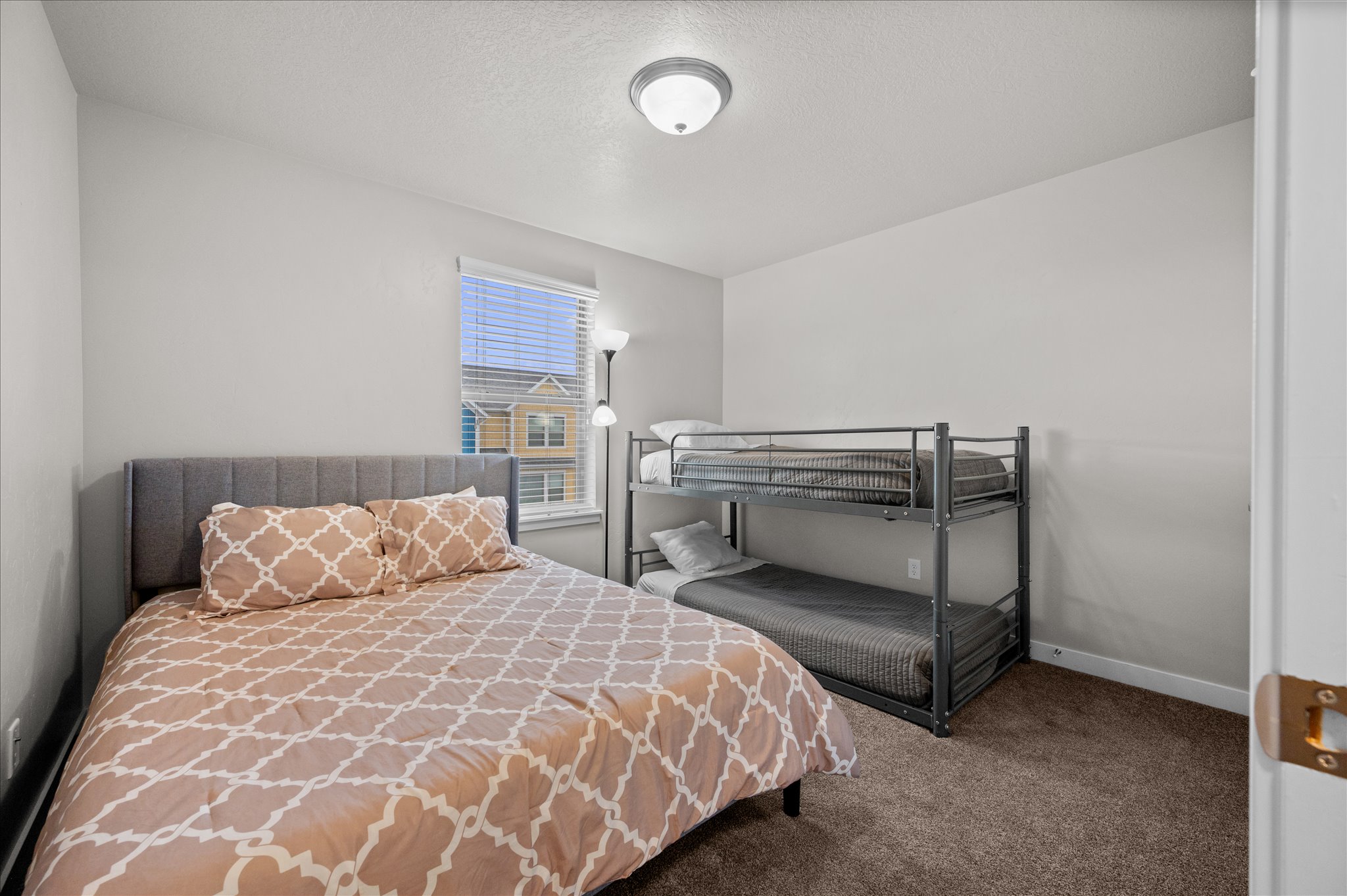 Bedroom featuring carpet and a textured ceiling