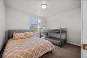 Bedroom featuring carpet and a textured ceiling