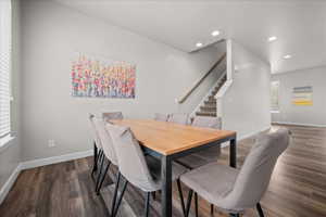 Dining area featuring dark wood finished floors and recessed lighting