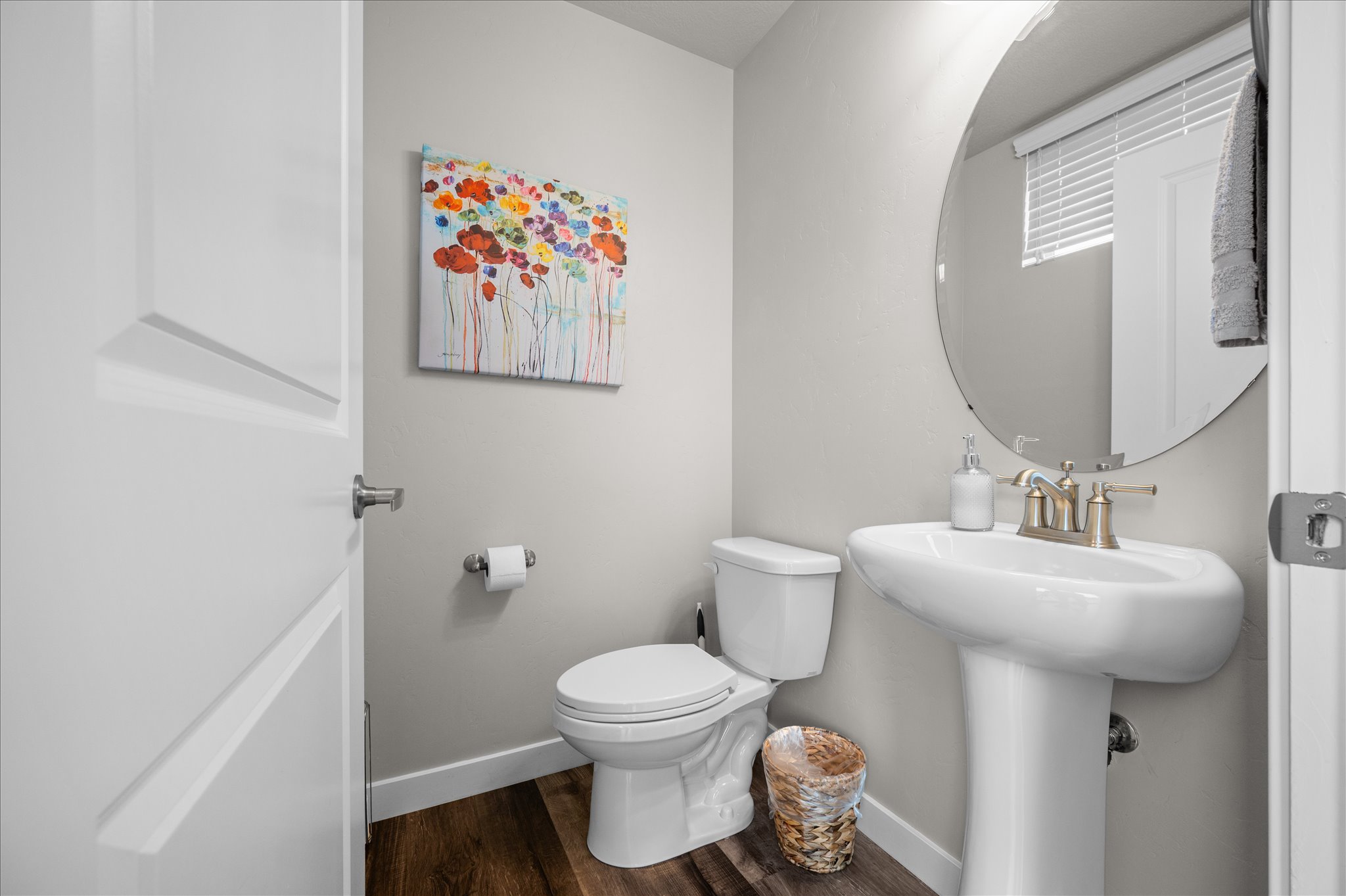Half bathroom with toilet and dark wood-type flooring
