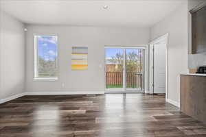 Unfurnished dining area with dark wood-style floors and recessed lighting
