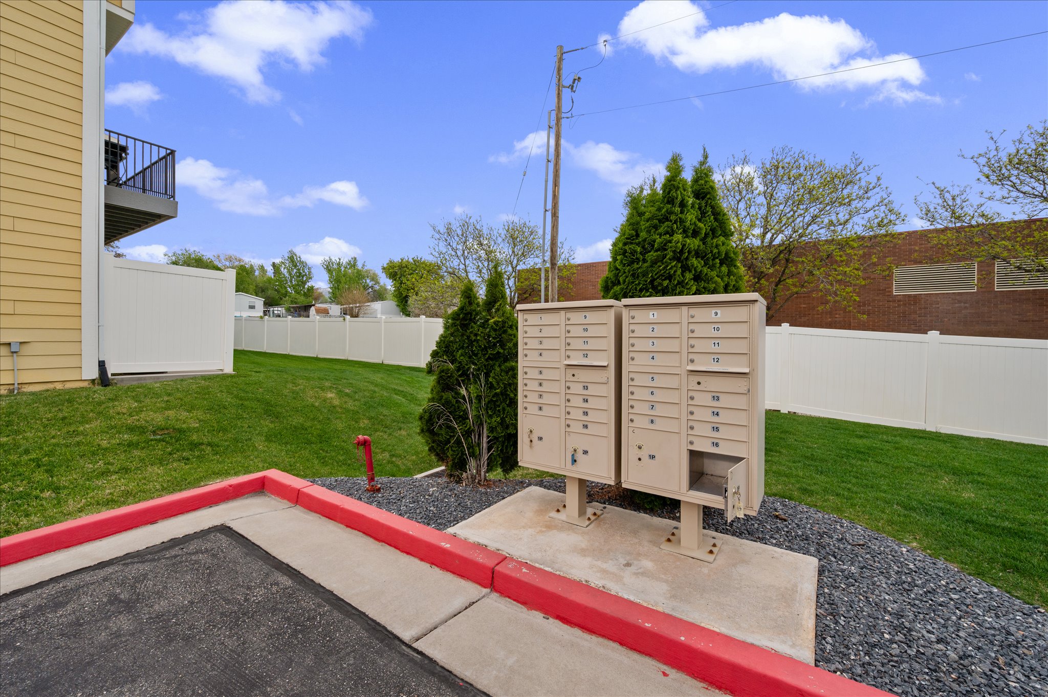 View of community with mail area, a patio area, and a balcony