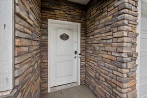View of exterior entry with stone siding