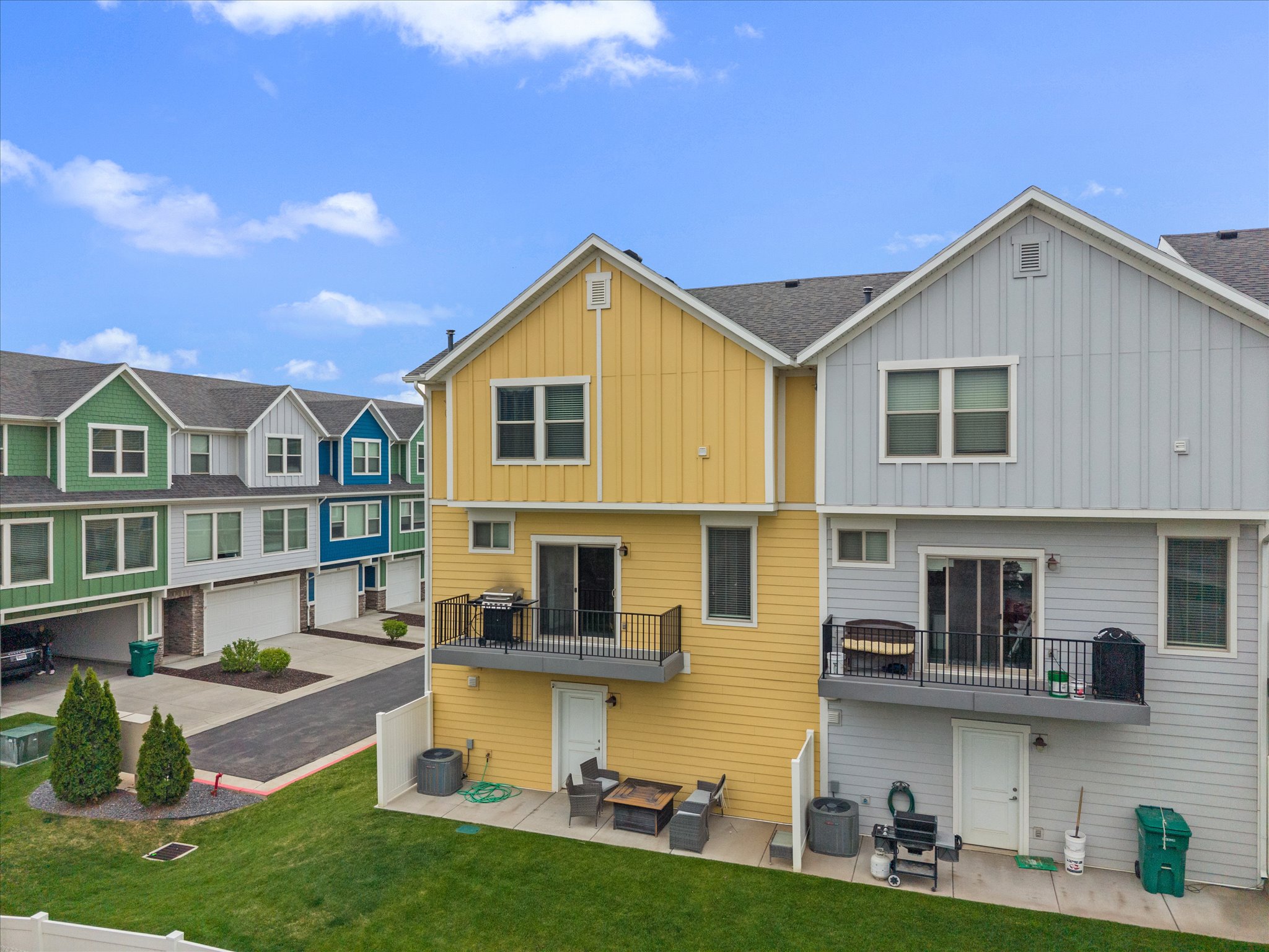 Back of property with a patio area, board and batten siding, and a residential view