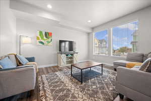 Living room with wood finished floors and recessed lighting